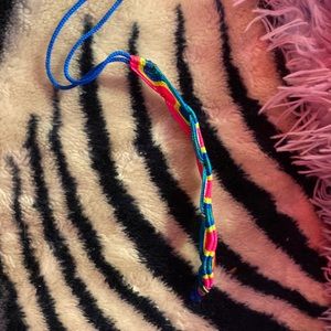 Home made neon summer bracelet in the colors pink yellow and blue.